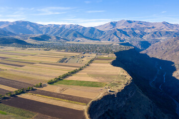 Wall Mural - Aerial view of farmlands, Debed river Gorge and Odzun village on sunny summer day. Lori Province, Armenia.