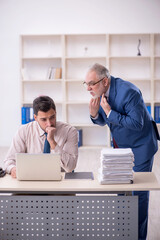 Wall Mural - Old male boss and young male employee in bullying concept