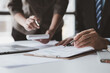 © kamiphotos - Businessman is reviewing monthly sales documents for analysis and marketing plans for more sales growth, they are the founders of young companies co-founding startups. Sales management concept.