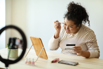 Wall Mural - Pretty young woman plus size recording video while applying makeup