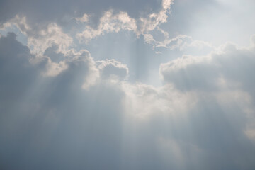 Wall Mural - Dramatic Sky and Sun Rays Background. Sunbeams Light and Moody Cloudscape. Sunbeam through the haze in cloudy day.
