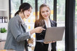 © NINENII - Two Young Asian businesswoman discuss with new startup project Idea presentation, analyze planning and financial statistics and investment market at office.