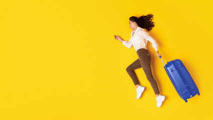 Wall Mural - Traveler Woman With Suitcase Running In Mid Air, Yellow Background