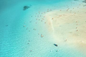 Canvas Print - Aerial view of blue sea and sandy beach with crowd of people in the morning at dawn in summer. Beautiful seascape, vacation background. Landscape top view