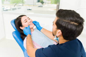 Wall Mural - Attractive woman with white healthy teeth at the dentist