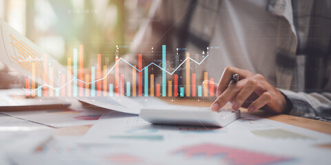 Aufkleber - accountant using a calculator to calculate numbers and reading graph report and business statistics charts ,Analysis and improvement of corporate strategy ,manage financial and marketing documents