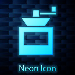 Poster - Glowing neon Manual coffee grinder icon isolated on brick wall background. Vector