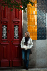 Wall Mural - A woman waits at the wall of a traditional Portuguese house.