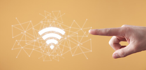 Wall Mural - male hand showing wireless technology symbol. wifi symbol with a network connection