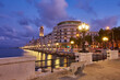 Empty benches and lamp posts at seafront and promenade in Bari, Italy. Romantic, calm, relaxing evening in city.