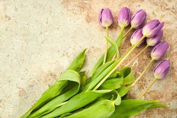 Wall Mural - Bouquet of purple tulips on a travertine stone background