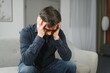 © Serhii - Closeup of middle-aged bearded man suffering from headache at home, touching his temples, panorama with copy space. Migraine, headache, stress, tension problem, hangover concept