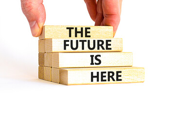 Wall Mural - The future is here symbol. Concept words The future is here on wooden block. Beautiful white table white background. Businessman hand. Motivational business the future is here concept. Copy space.