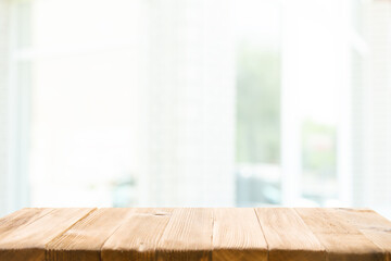 Empty wooden table top on window blur and abstract with sunlight. For mounting product display or visual