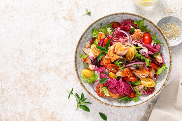 Salad of grilled salmon fillet, tomato and fresh lettuce salad, healthy food, lunch, top view