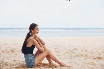 woman sitting smile freedom travel nature sand vacation sea hair beach