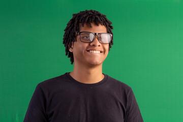 Young dark-skinned man with curly hair making facial expressions in studio photo.