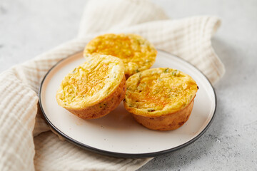 Poster - Savory muffins with egg, feta cheese, cheddar and spinach on light background