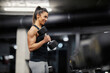 © Dusan Petkovic - A muscular strong female bodybuilder is lifting dumbbell in a gym during her strength training.