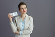 © Alliance - pensive elegant business owner woman in light business suit