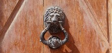Door Handle With Ring And Lion. Antique Handle With A Lion's Head And A Ring On A Wooden Door. Metal Lion Head. Antique Doorknob Swept Away.