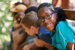 © Jeff Bergen/peopleimages.com - Black girl, camp or friends portrait with happiness or glasses outdoor. Happy, African and female teen with face and a smile from summer camping, holiday or team building with fun people in treehouse