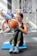 © JoseIMartin - Sporty woman exercising with ball on fitness mat at the gym. Sports and healthy lifestyle concept.