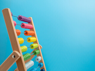 Wooden abacus on a blue background, Wooden abacus for children.