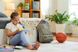© DragonImages - Preteen girl sitting on floor in bedroom and doing homework after classes