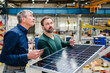 © Westend61 - Manager and businessman discussing over solar panel at factory