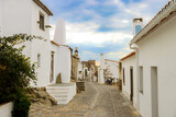 Fototapeta Uliczki - Monsaraz town in Portugal by the riverside - a street with white houses