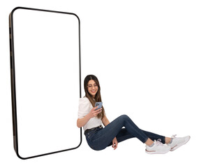 Woman using smartphone, sitting on floor near giant mobile phone with empty white screen for mockup. Full body length studio shot. Website, application recommending advertising concept, copy space.