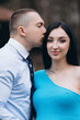 © Vitaliy - A young man kisses his pregnant wife's face.