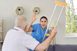 © Studio Romantic - Angry elderly man threatening nurse to hit her with crutch. Enraged exasperated senior man abusing and threatening scared female caretaker, volunteer with his cane