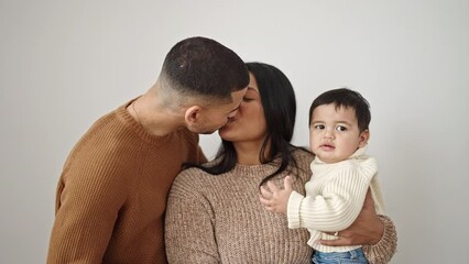 Wall Mural - Couple and son kissing and hugging each other standing over isolated white background