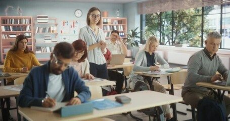 Fototapete - Multiethnic Women and Men of Different Age Acquiring New Academic Skills in Classroom. Formal Adult Learning Activity, Undertaken by Diverse Mature Students After Finishing School and College