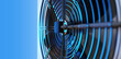 Air conditioning fragment. Fan behind metal mesh. Close-up of air conditioner unit. Equipment for re-circulation. Ventilation technologies. Air conditioner on blue. Climatic equipment