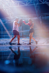 Female kickboxing training with male trainer gives self-defense classes to female fighter at GYM. Asian beautiful young woman exercise with trainer , boxing gloves, uppercut short, boxing, training