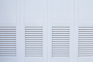 Closed white doors. Natural wooden background with space for text