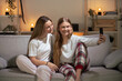 © Egoitz - Two women wearing pajamas taking selfie