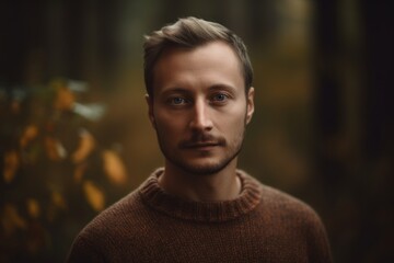 Wall Mural - Portrait of a handsome young man in the autumn forest. Men's beauty, fashion.