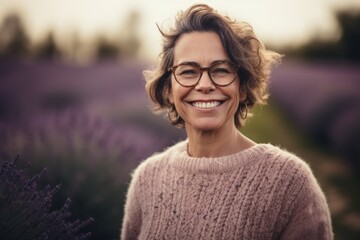 Wall Mural - Portrait of a smiling middle-aged woman in a lavender field