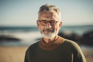 Wall Mural - Environmental portrait photography of a satisfied man in his 60s wearing a cozy sweater against a summer landscape or beach background. Generative AI