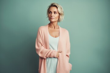 Wall Mural - Portrait of a beautiful middle-aged woman in a pink sweater