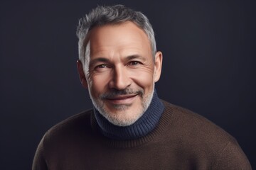 Wall Mural - Portrait of handsome middle-aged man in sweater on dark background
