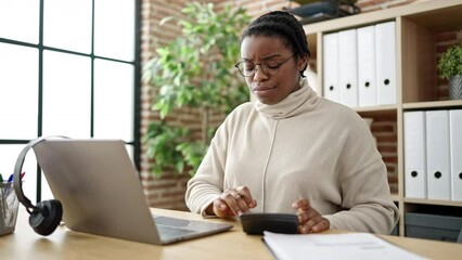 Poster - African american woman business worker tired using laptop and calculator at office