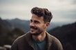© Robert MEYNER - Portrait of a handsome young man smiling and looking away in the mountains