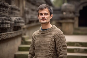 Sticker - Group portrait photography of a pleased man in his 30s wearing a cozy sweater against a temple or sacred site background. Generative AI