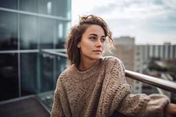 Lifestyle portrait photography of a pleased woman in her 20s wearing a cozy sweater against a rooftop or terrace background. Generative AI