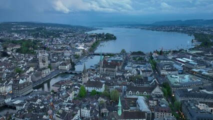 Wall Mural - Aerial view over City of Zürich with church towers and medieval old town on a cloudy spring evening. Movie shot May 6th, 2023, Zurich, Switzerland.